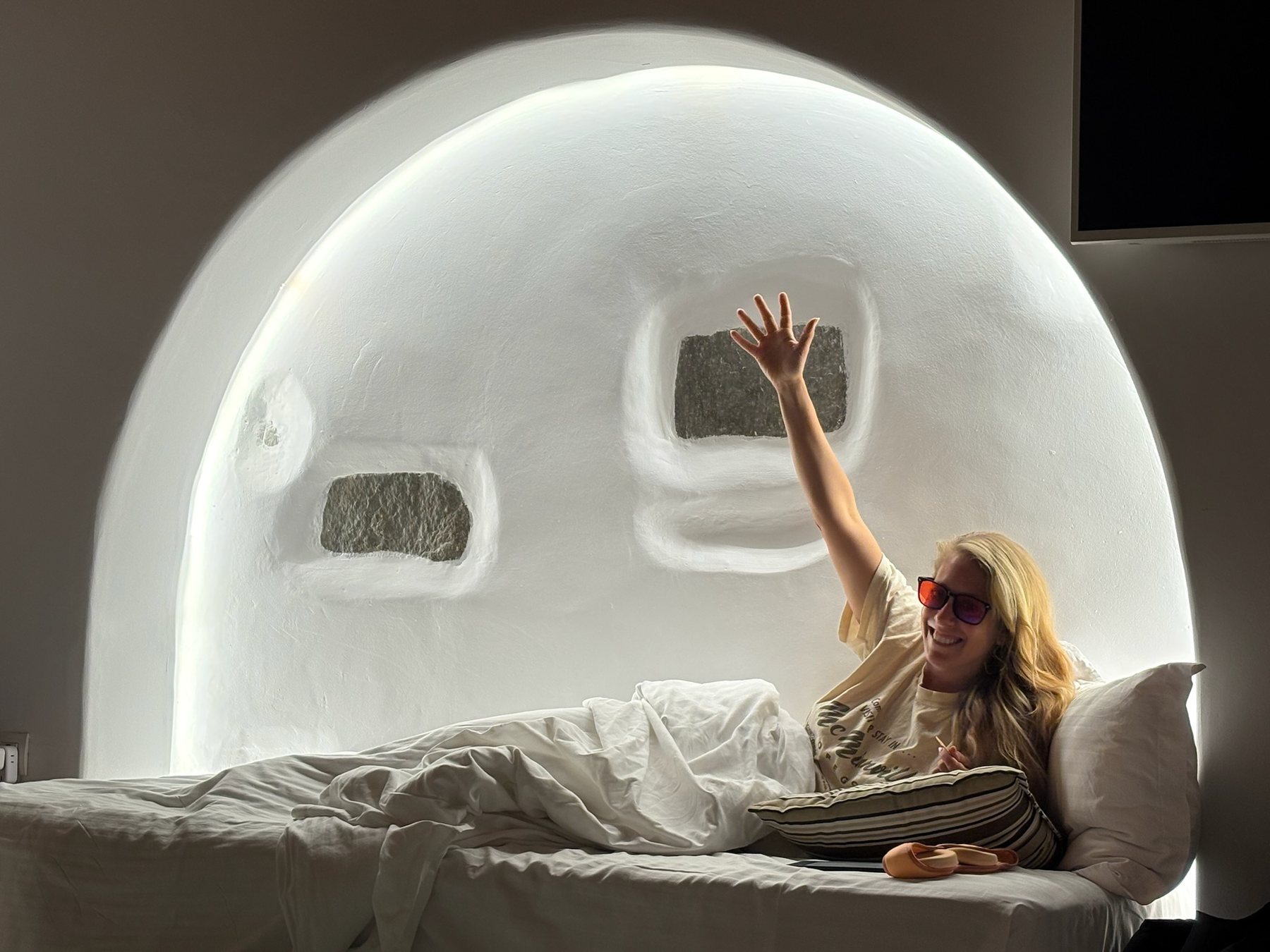 Tess resting in a light-filled bedroom