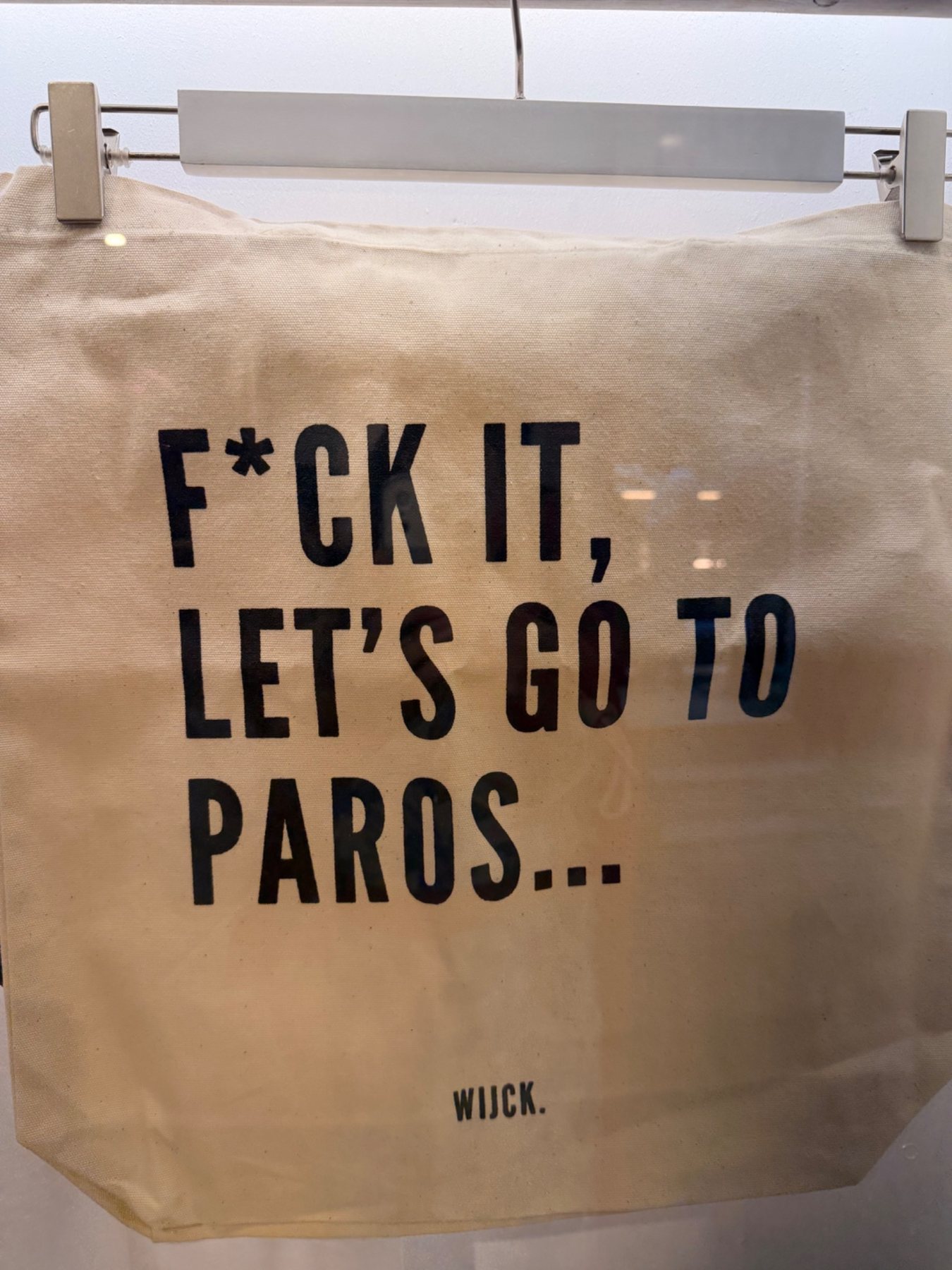 A tote bag with a playful travel slogan